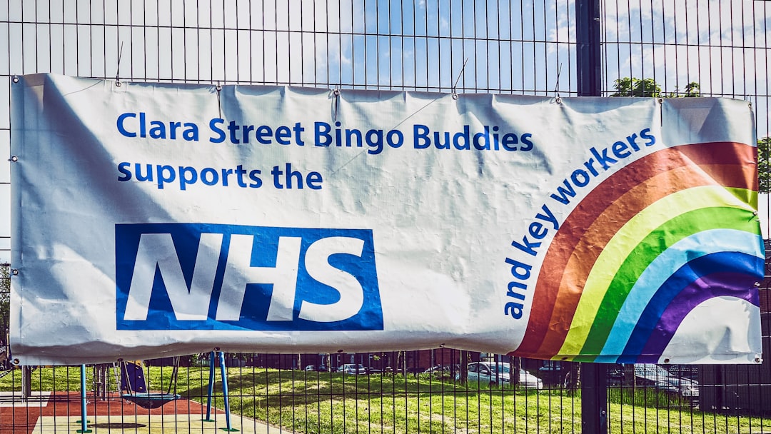 a banner on a fence that says clara street bingo buddies supports the new york yankees