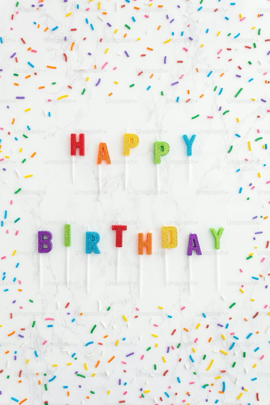 a birthday cake with candles that spell out happy birthday