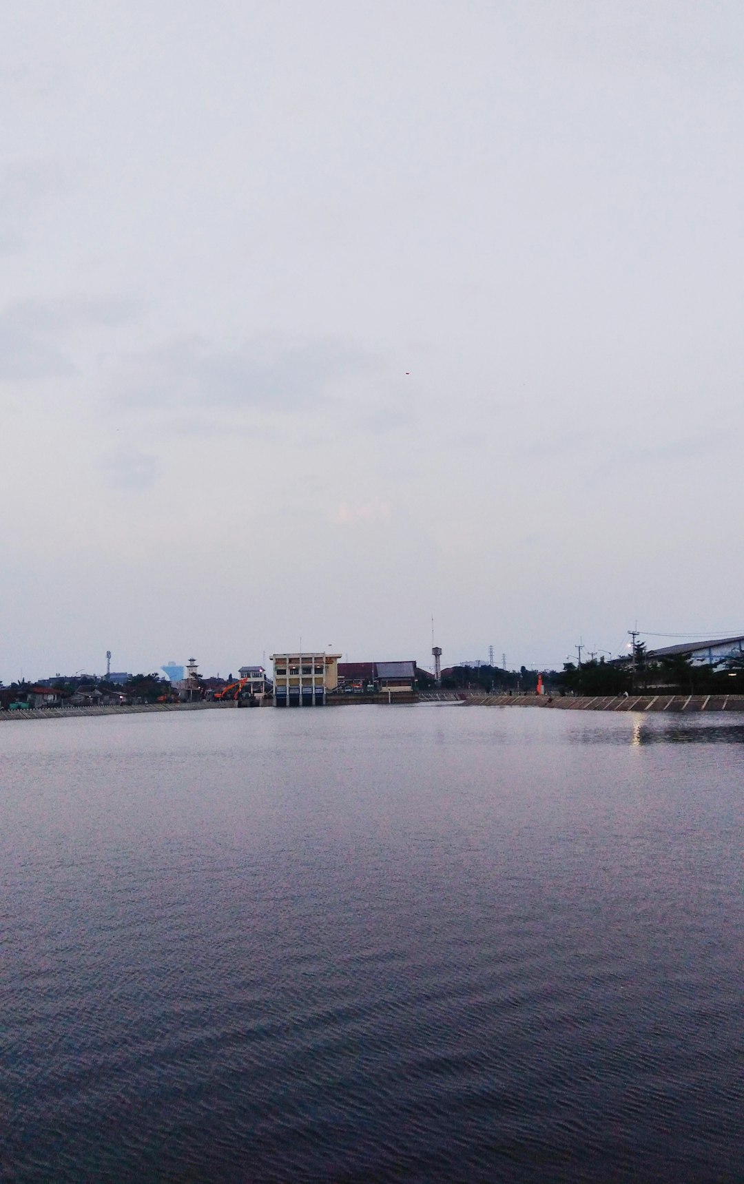 a body of water with buildings in the background