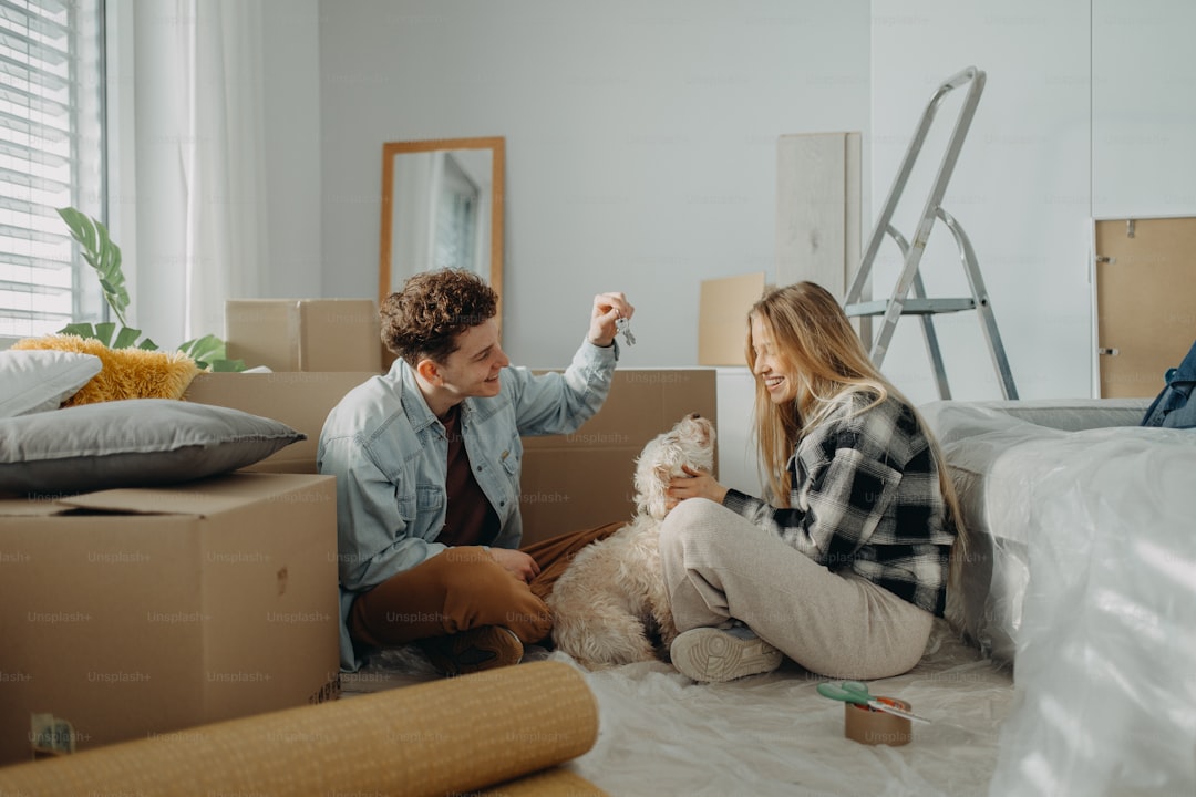 A cheerful young couple in their new apartment. Conception of moving.