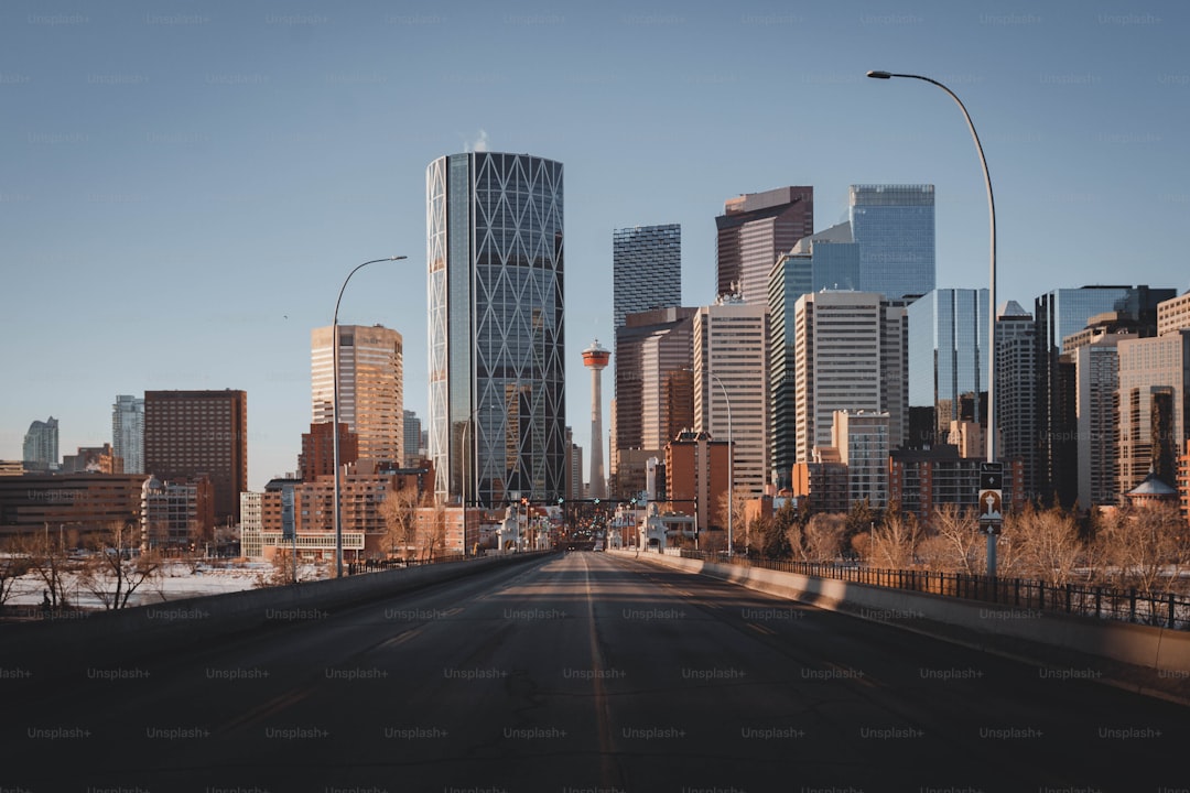 a city street with tall buildings in the background