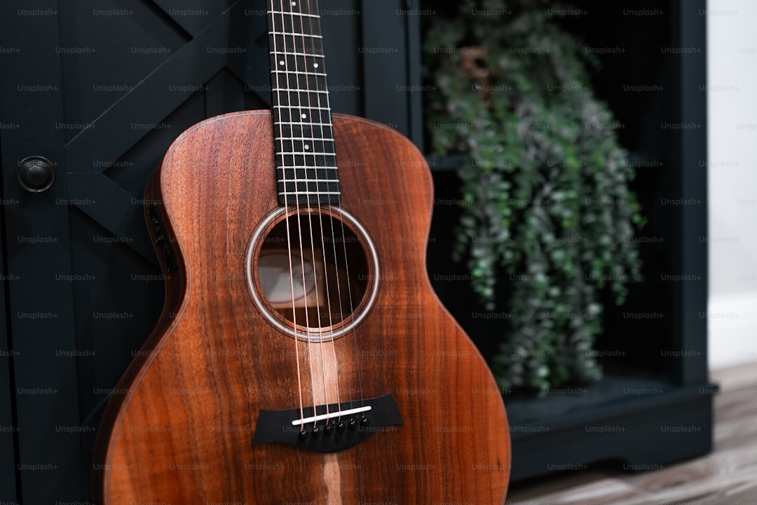 a close up of a guitar on a stand