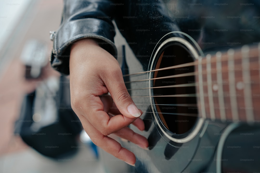 a close up of a person playing a guitar