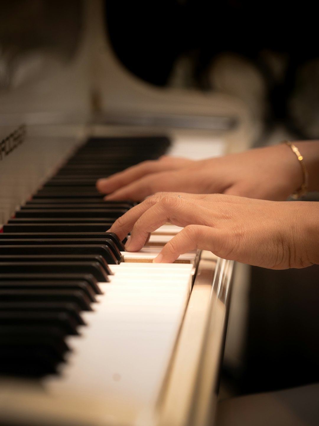 A close up of a person playing a piano