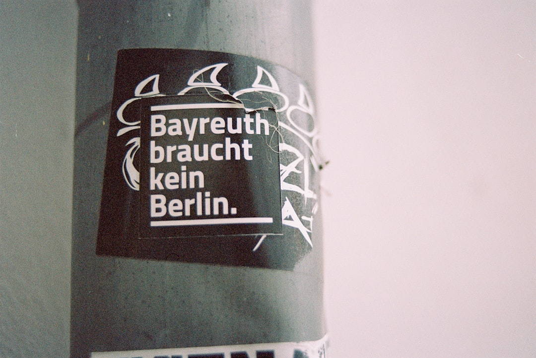 a close up of a street pole with a sticker on it