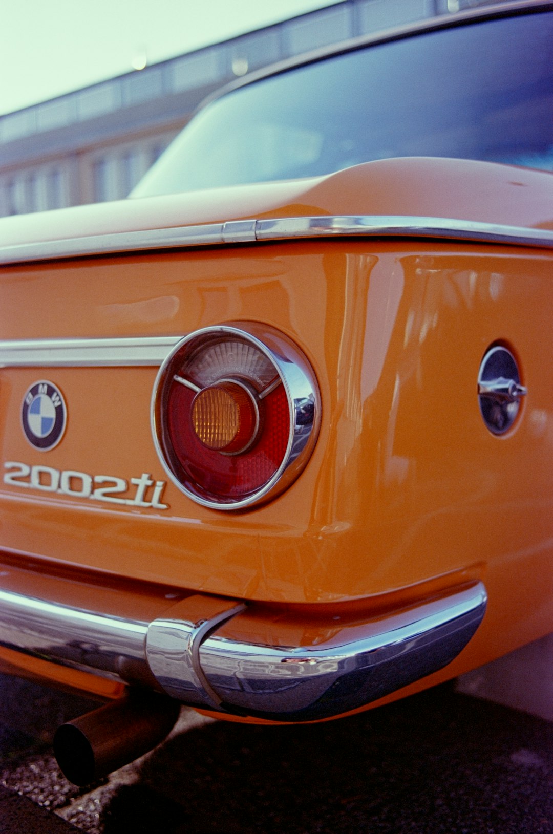 a close up of the tail end of an orange car