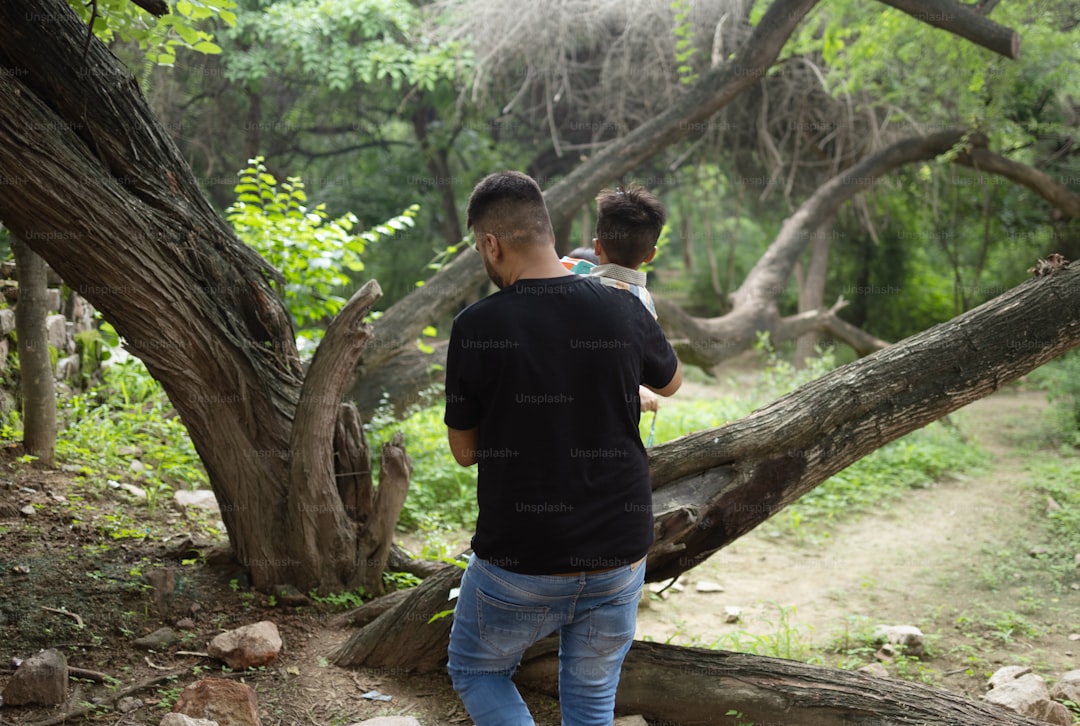 A couple of men standing on top of a forest