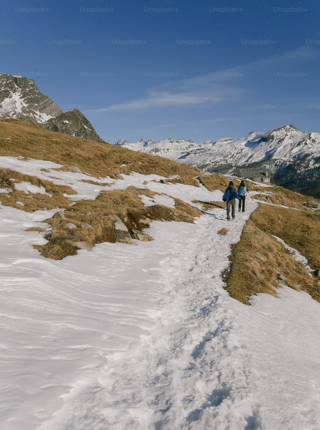 a couple of people that are walking in the snow