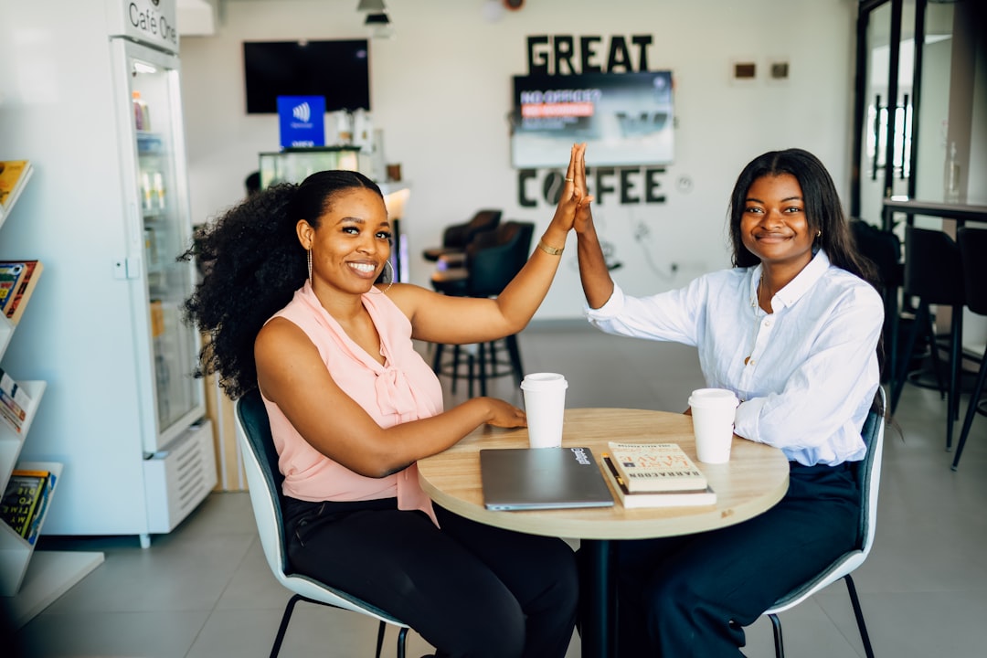 A couple of women sitting at a table