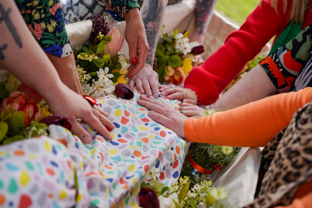 a group of people holding hands over a baby's foot