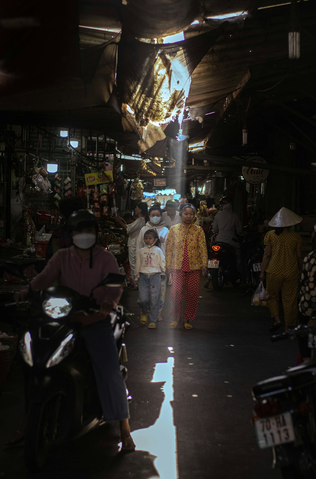 a group of people riding motorcycles down a street