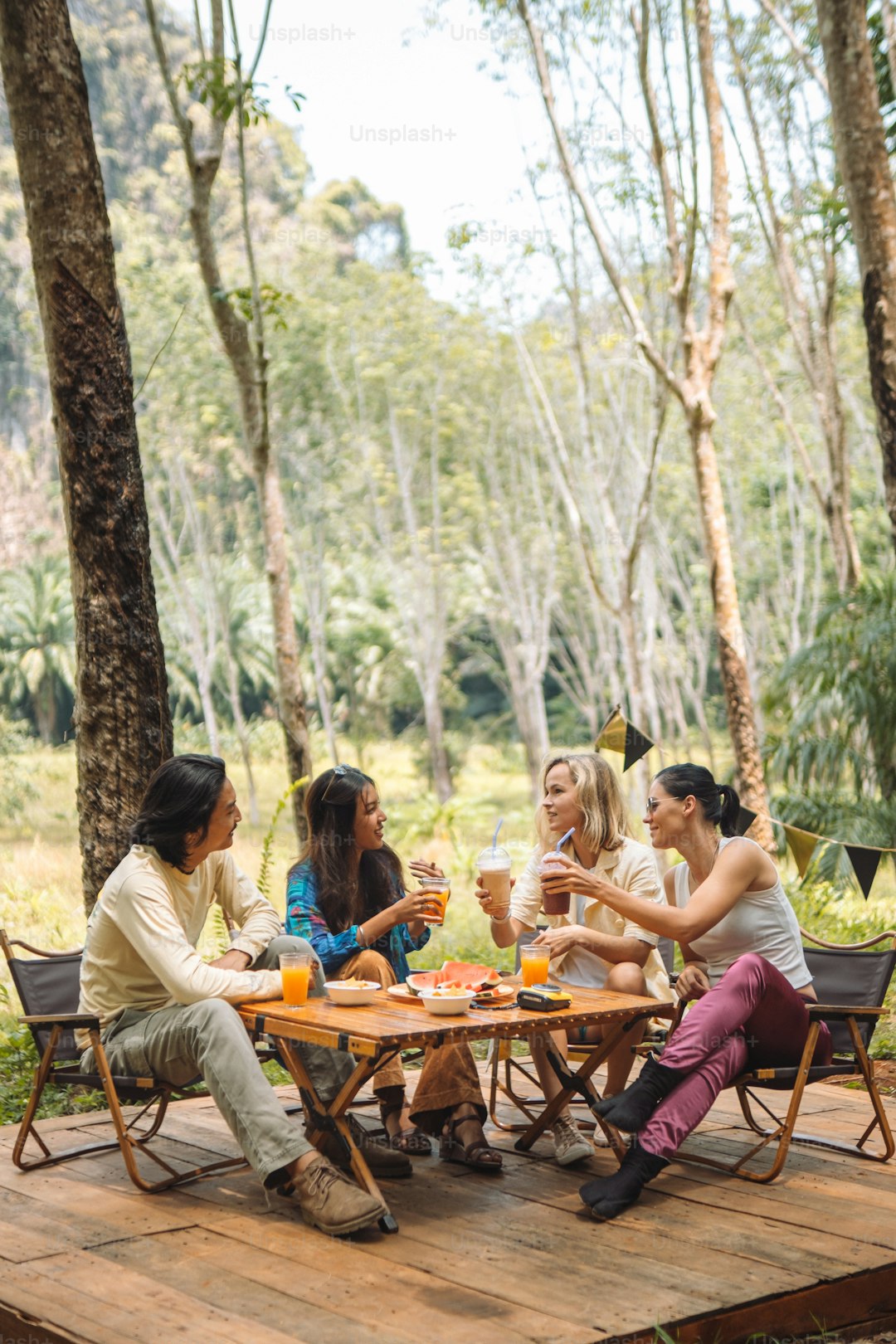 a group of people sitting around a table with drinks