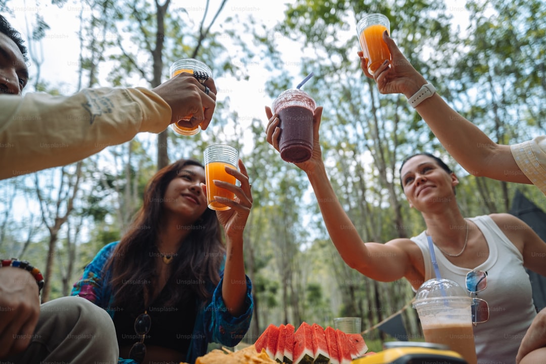 a group of people sitting around a table with drinks