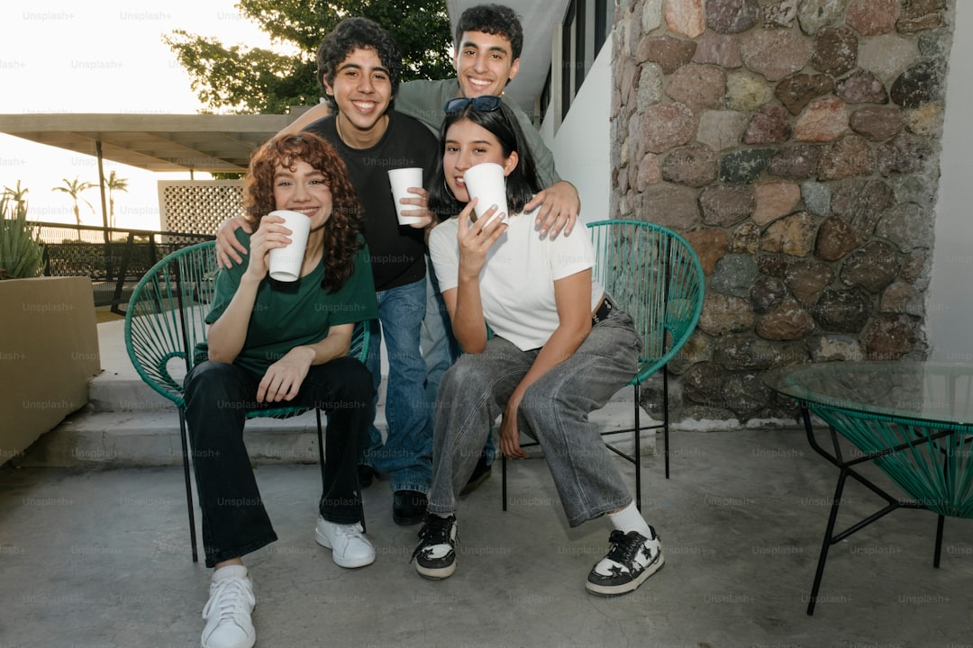 A group of people sitting around each other