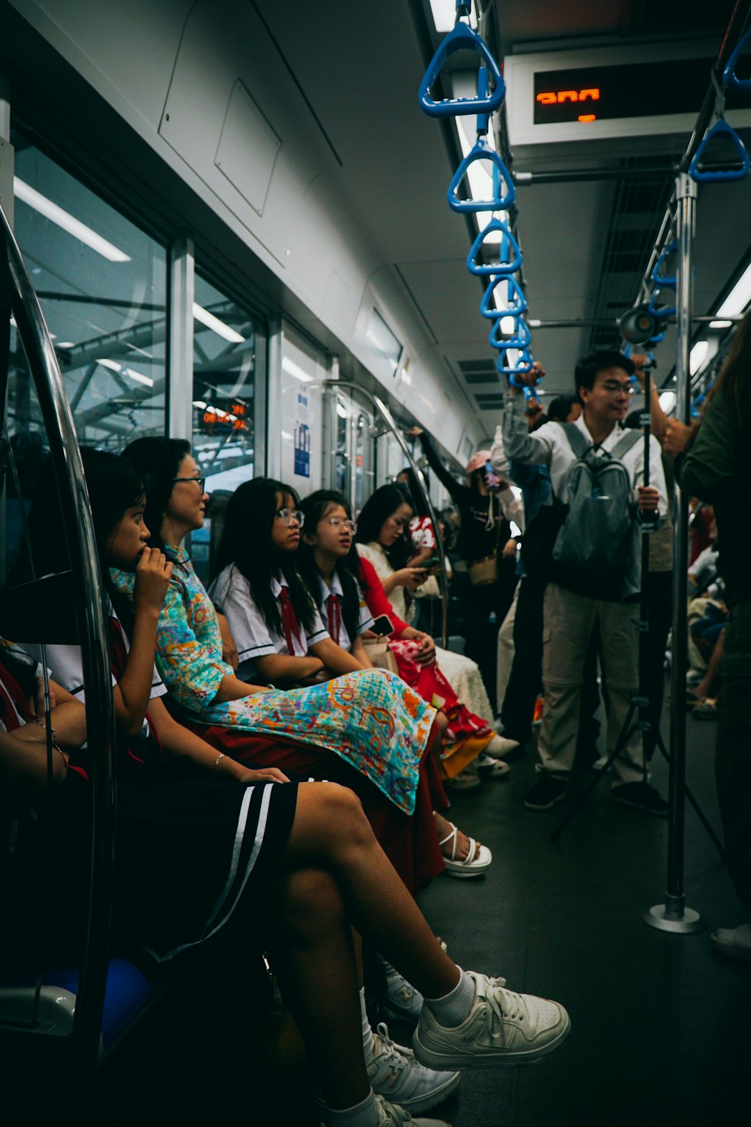 A group of people sitting on a subway train