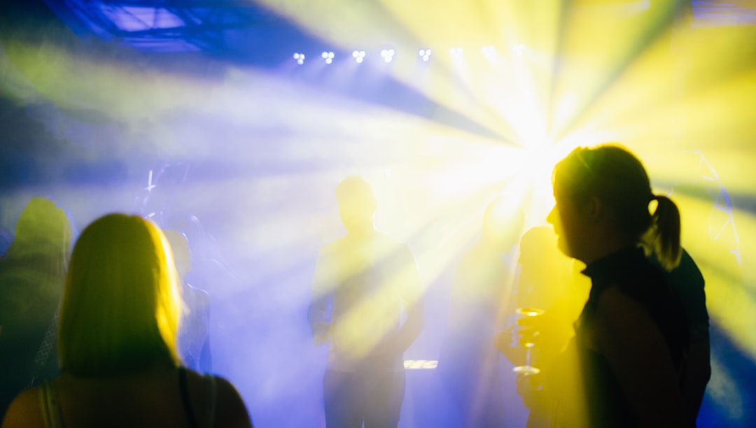 a group of people standing in front of a bright light