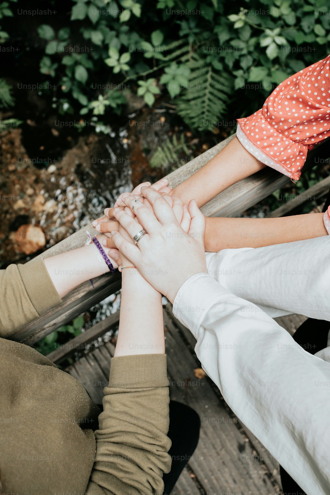 a group of people standing next to each other holding hands