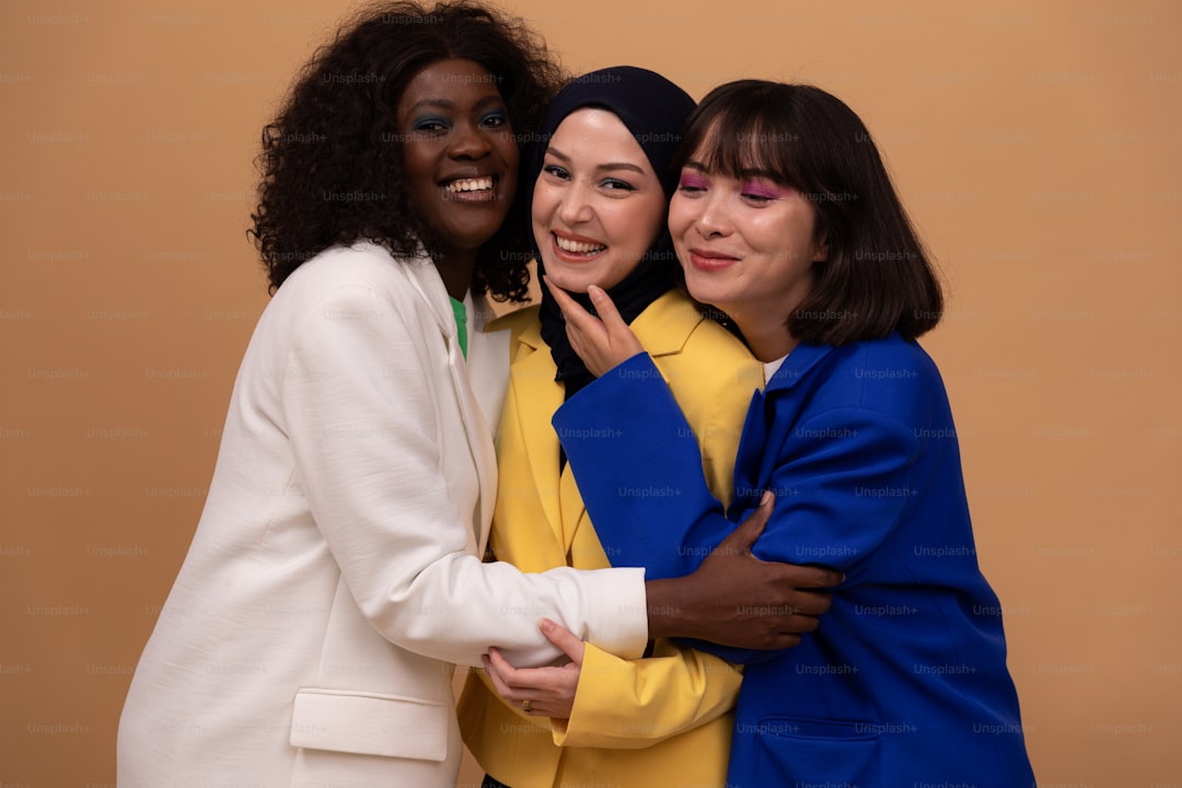 a group of three women standing next to each other