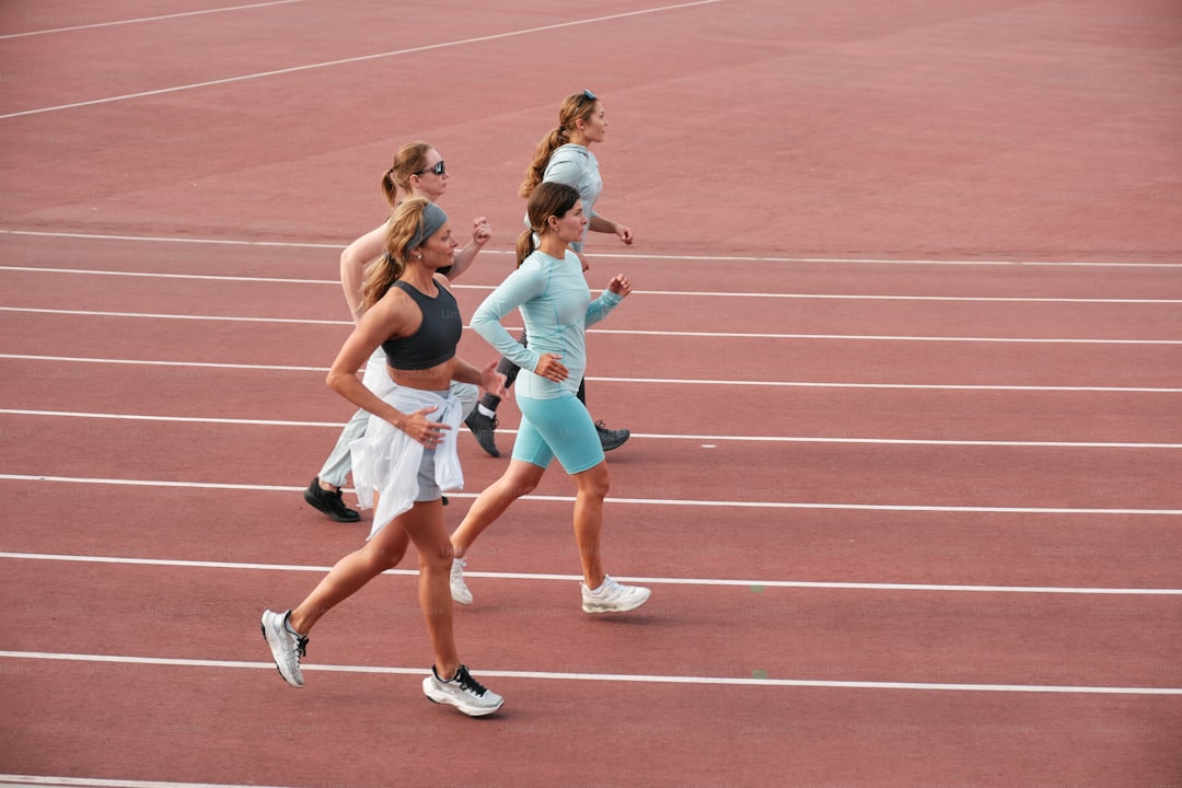 A group of women running across a track