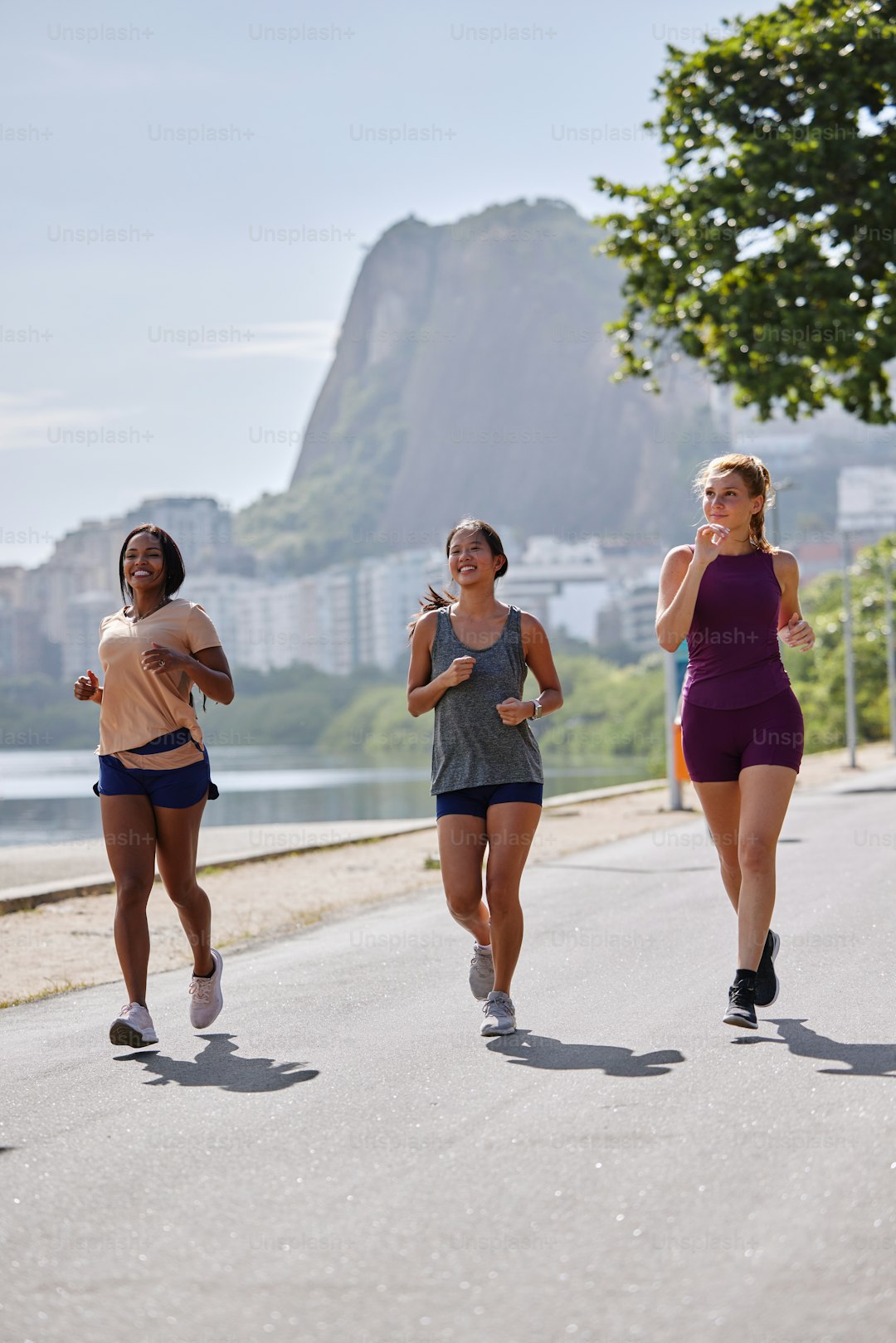 a group of women running down a street