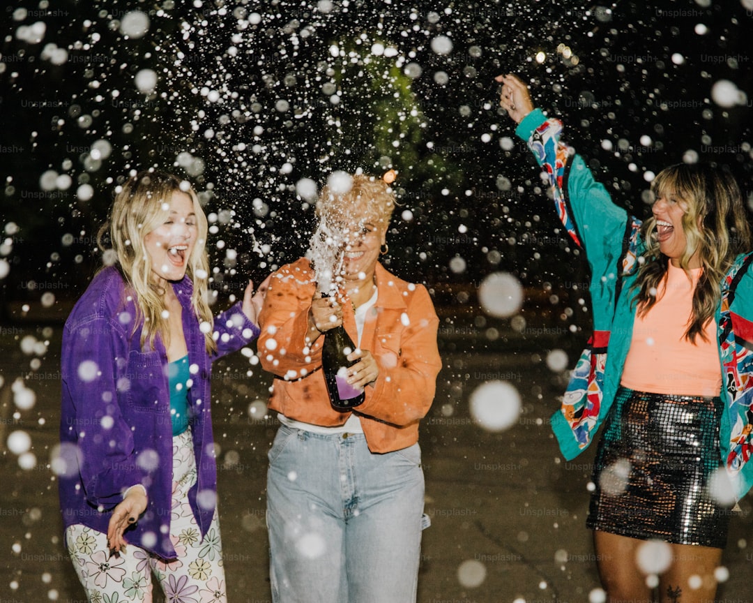 a group of women standing next to each other in the snow