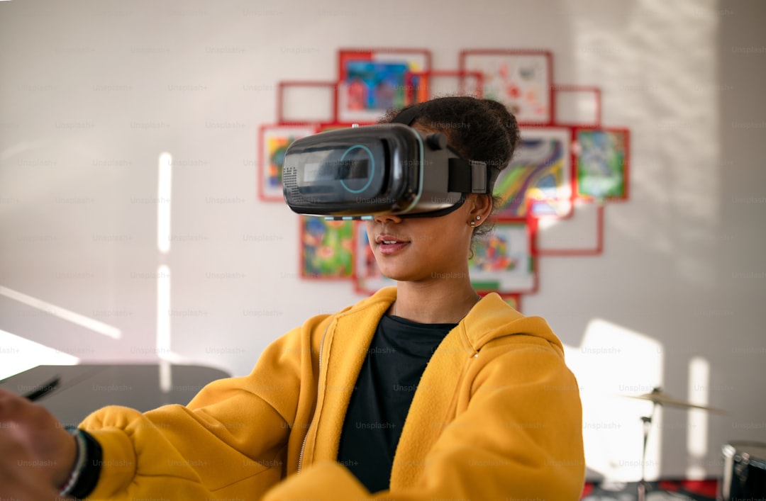 A happy student wearing virtual reality goggles at school in computer science class