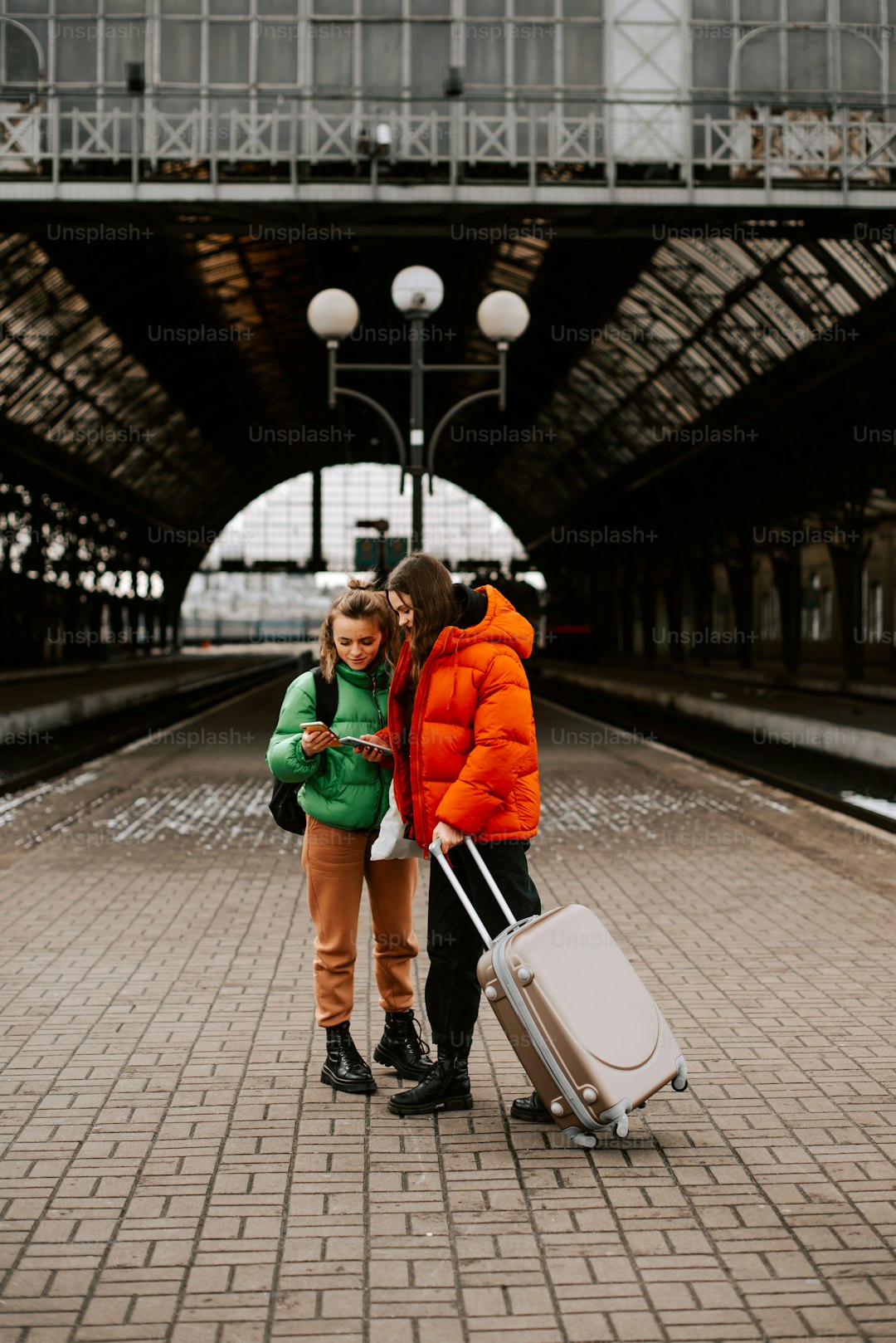 a man and a woman standing next to each other with luggage