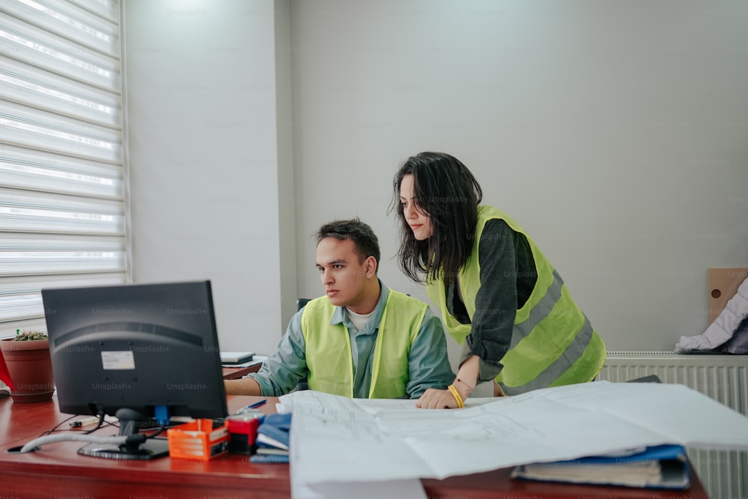 a man and a woman working at a desk