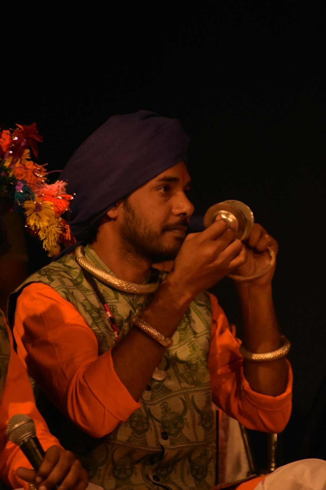 A man in a turban drinking from a glass