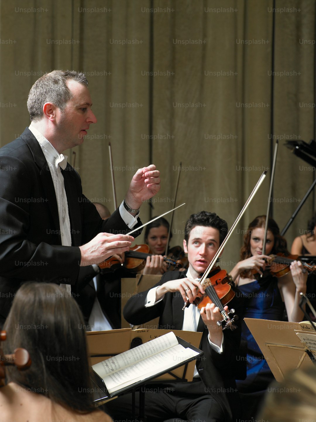 a man in a tuxedo playing the violin