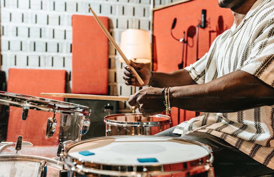 a man is playing drums in a room