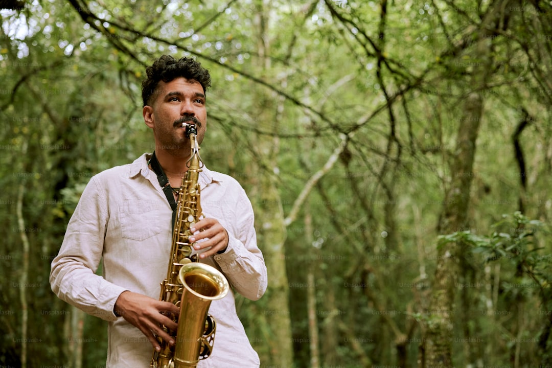 a man playing a saxophone in a forest