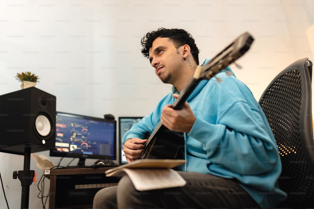 a man sitting in a chair holding a guitar