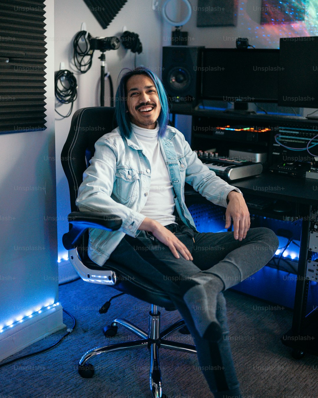 a man sitting in a chair in front of a desk