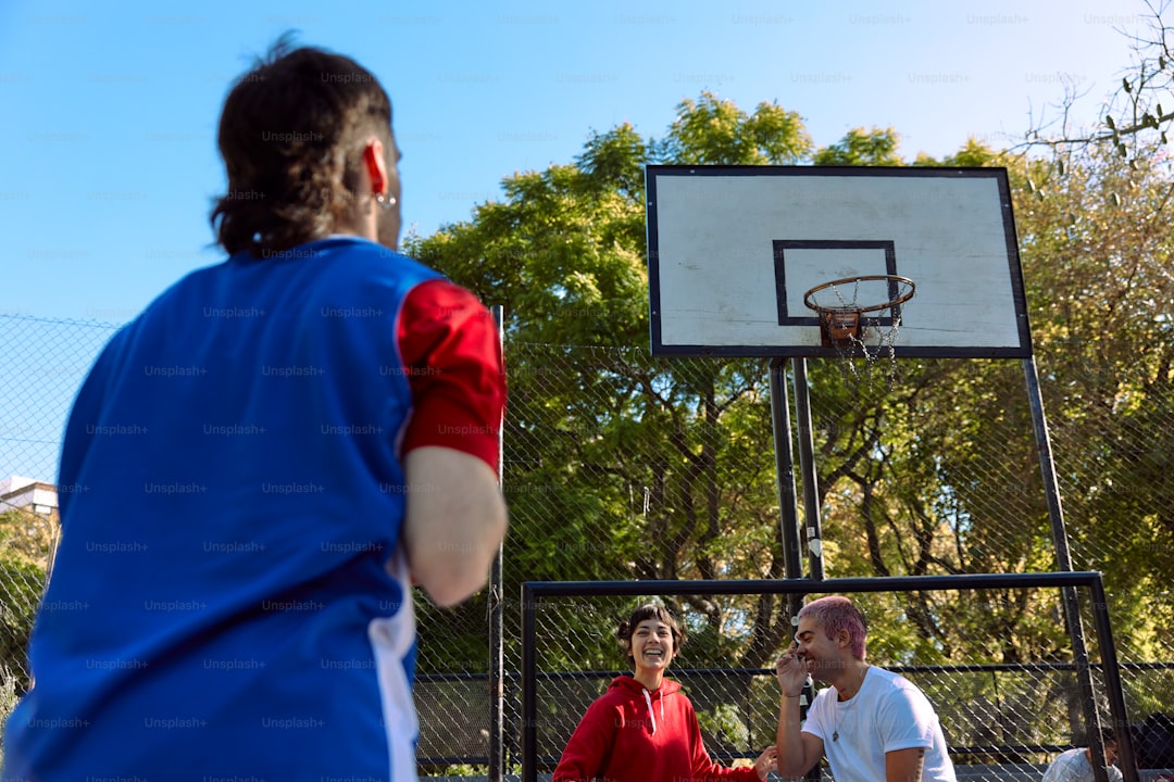 a man standing next to a woman on a basketball court