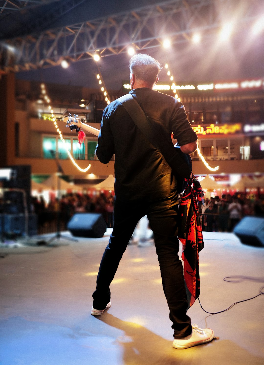 A man standing on top of a stage holding a guitar