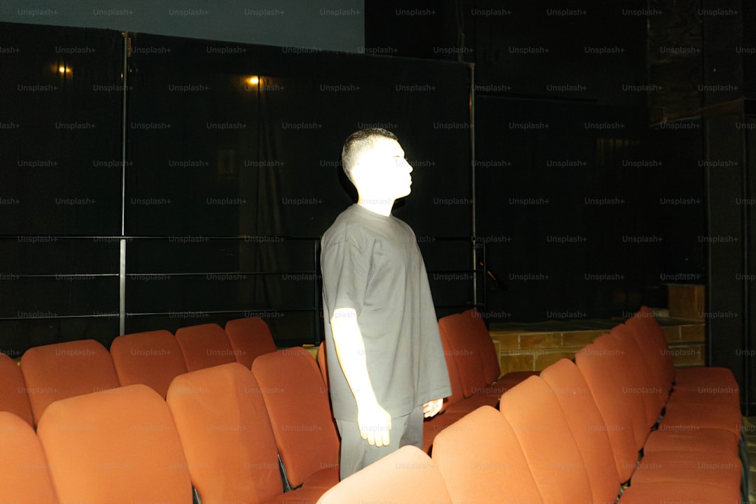 A man stands in an empty theater.