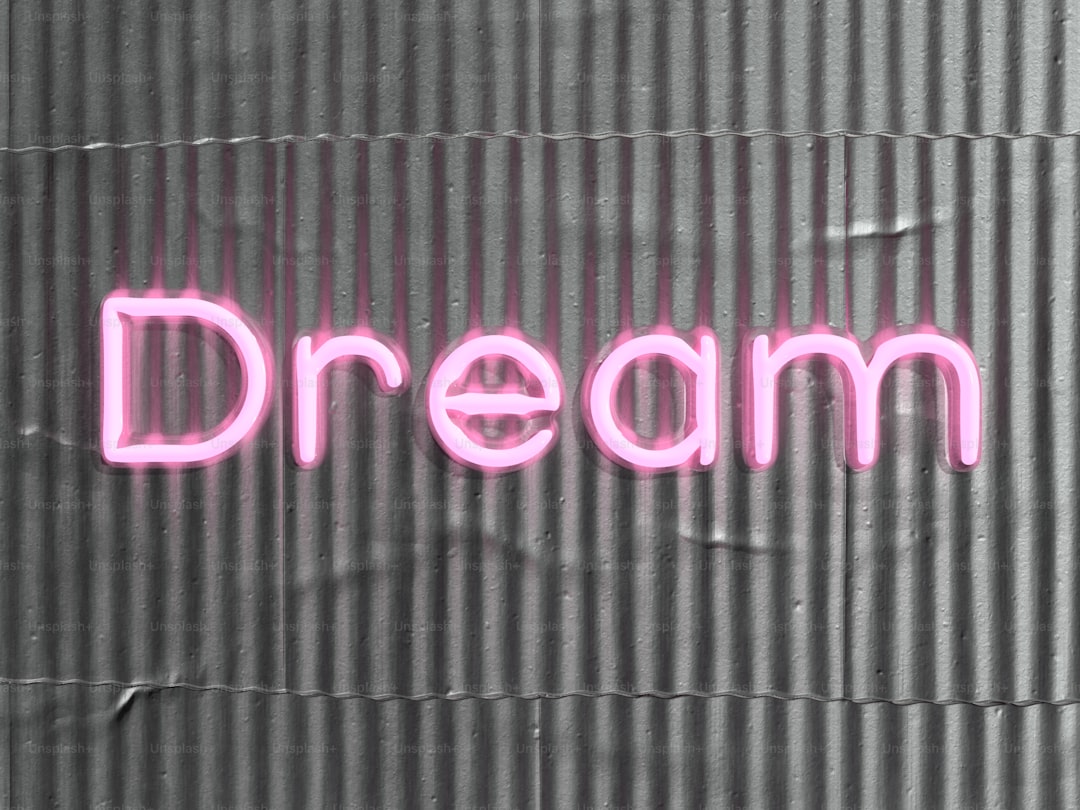 a neon sign that says dream on a wall