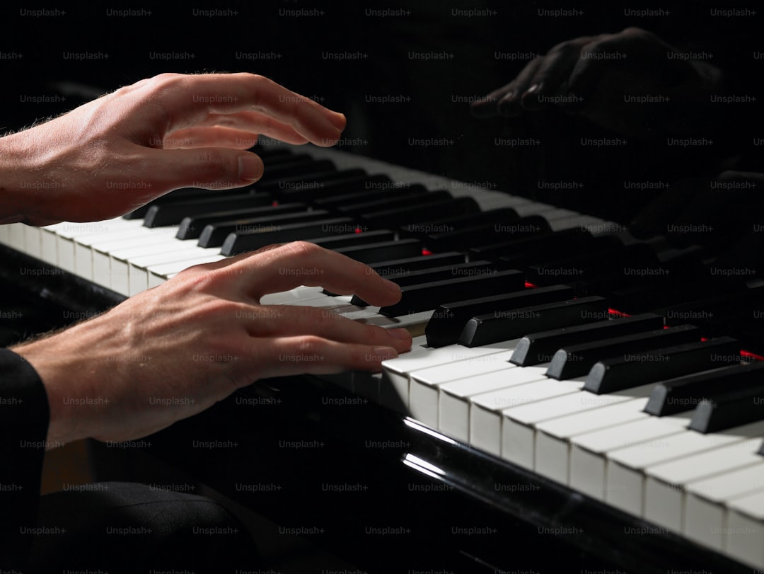 a person playing a piano with their hands