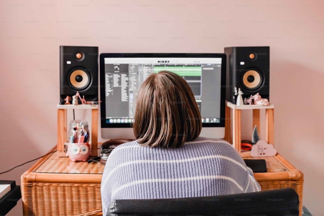 a person sitting at a desk in front of a computer