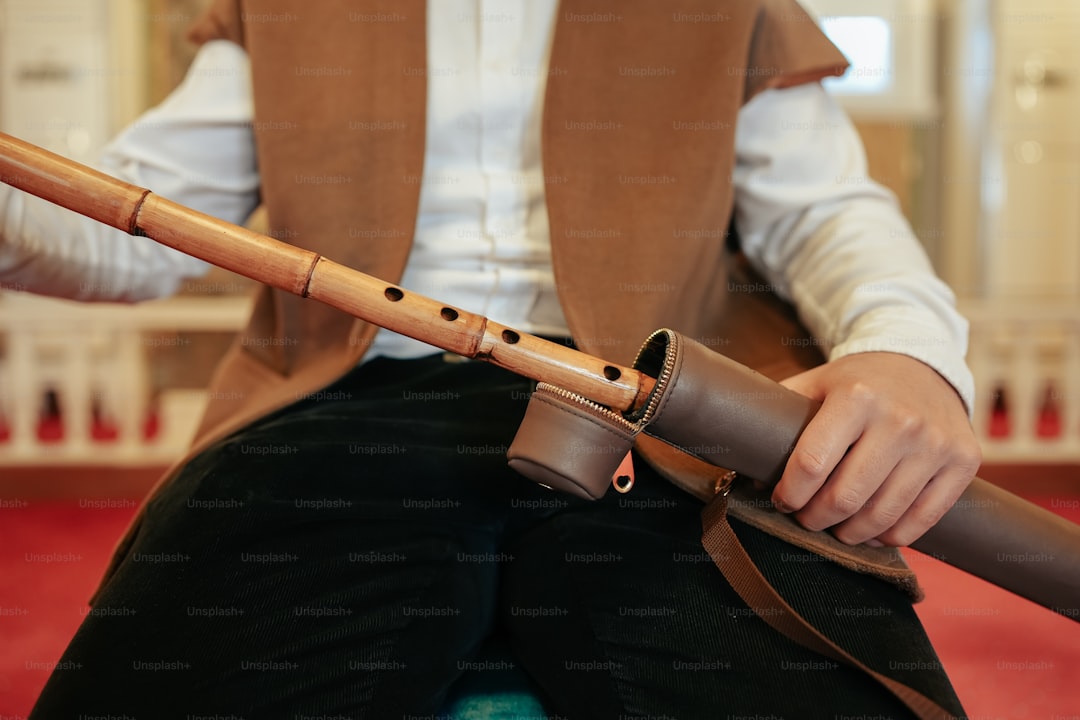 a person sitting on a chair holding a flute