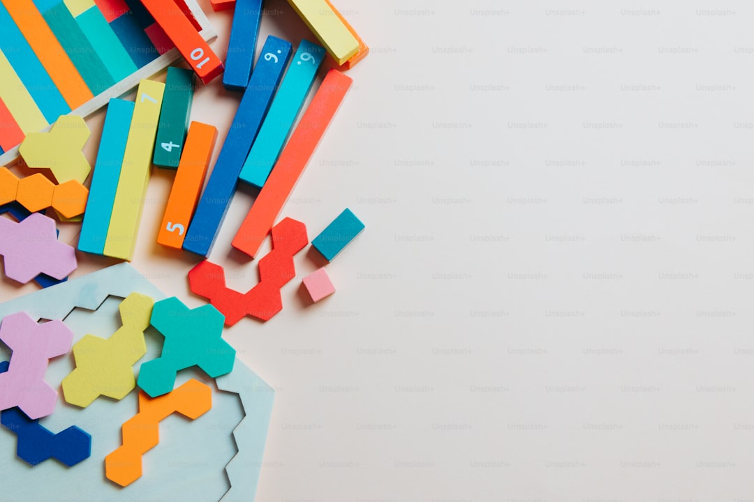 a pile of colorful wooden toys on a white surface