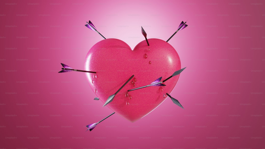 A pink heart with two arrows sticking out of it