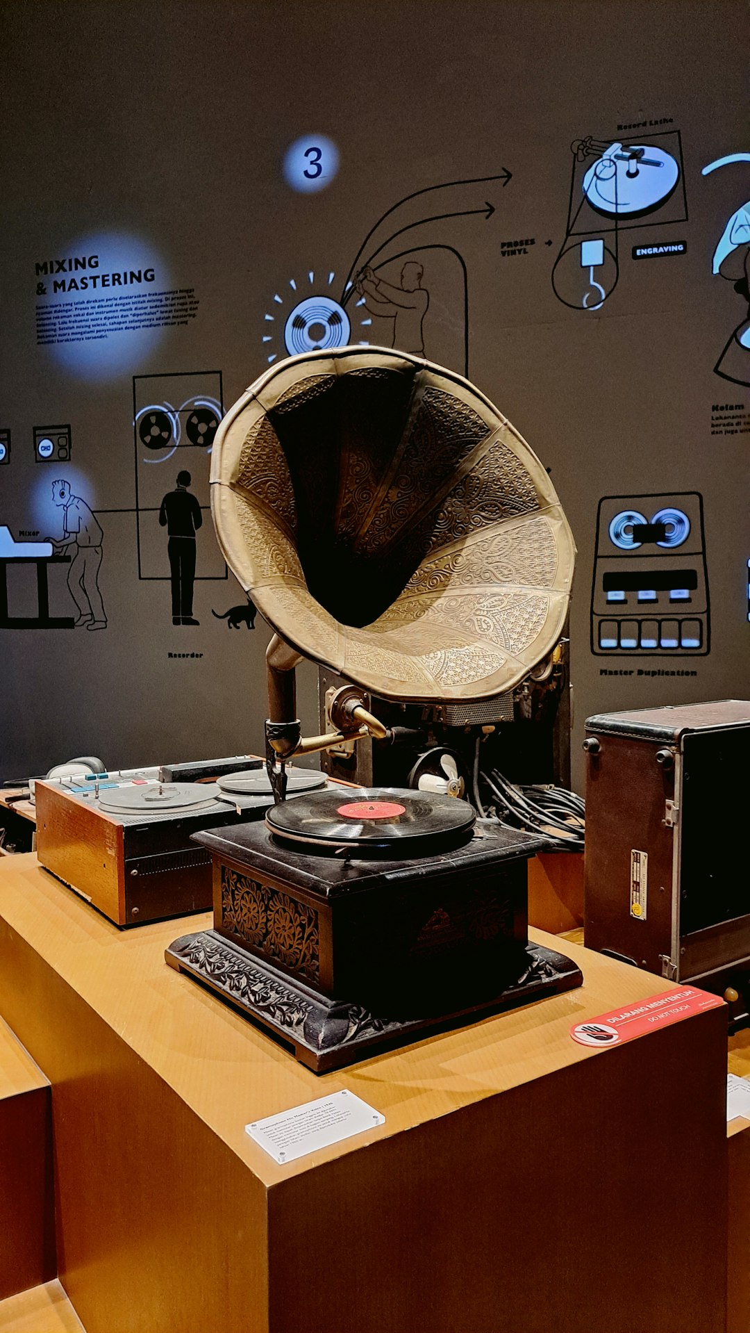 A record player sitting on top of a wooden table