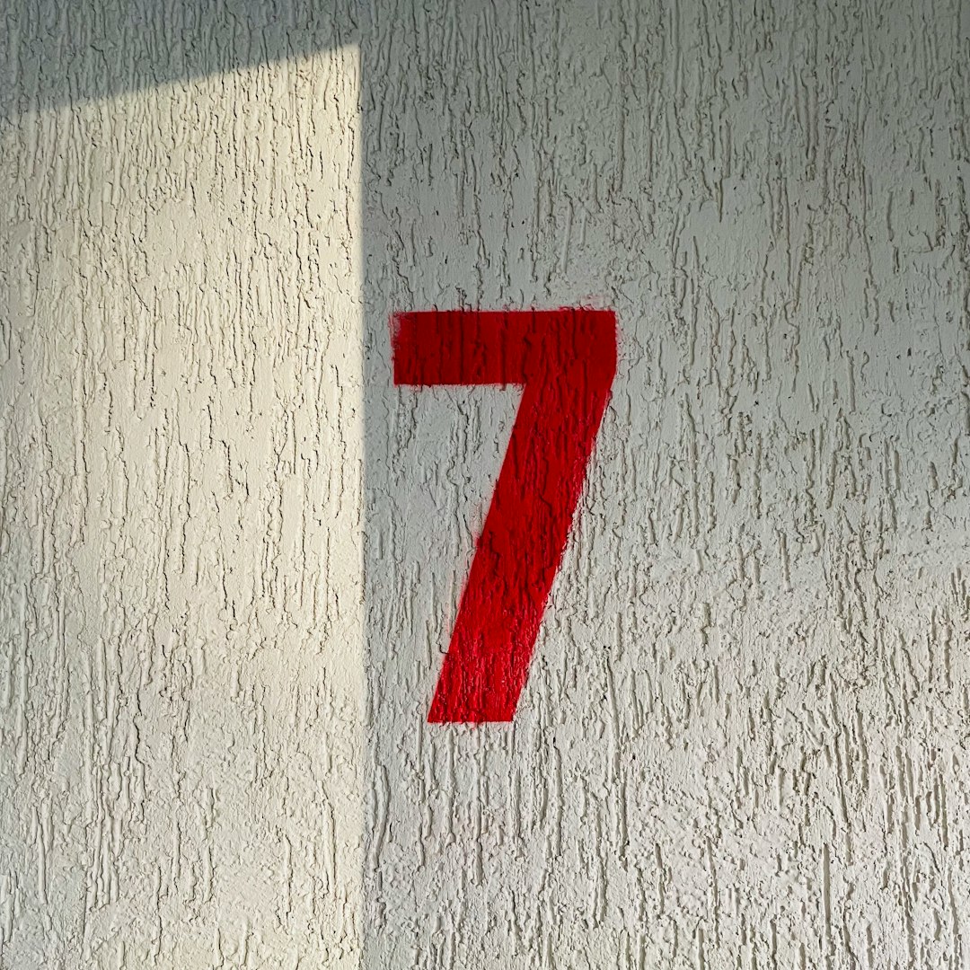 a red number seven on a white wall