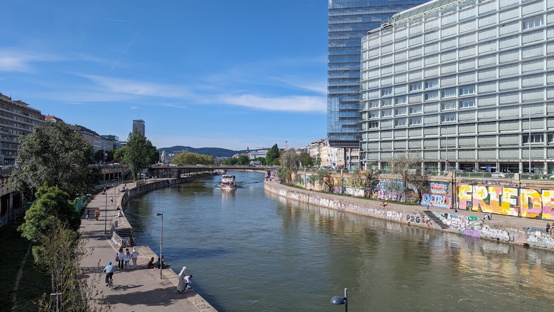 A river running through a city next to a tall building