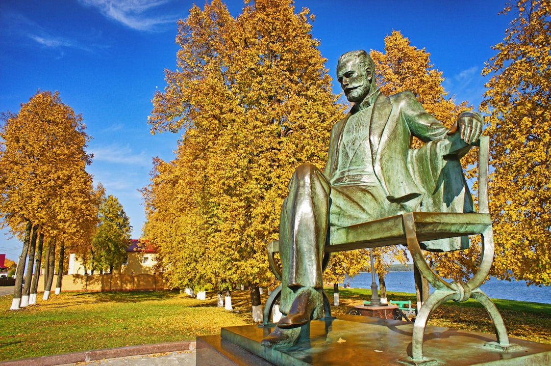 a statue of a man sitting on a bench