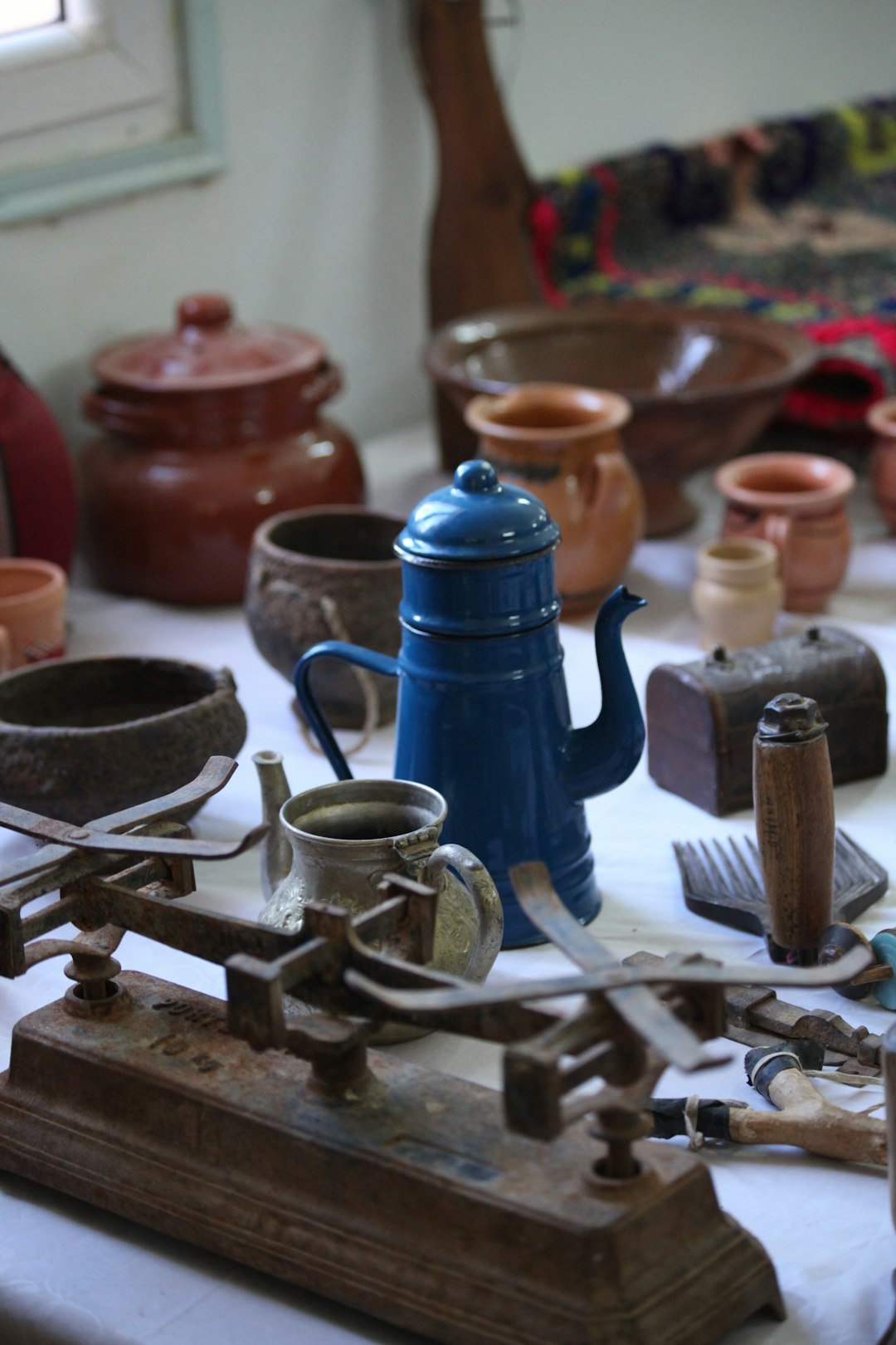 A table topped with lots of different types of pottery