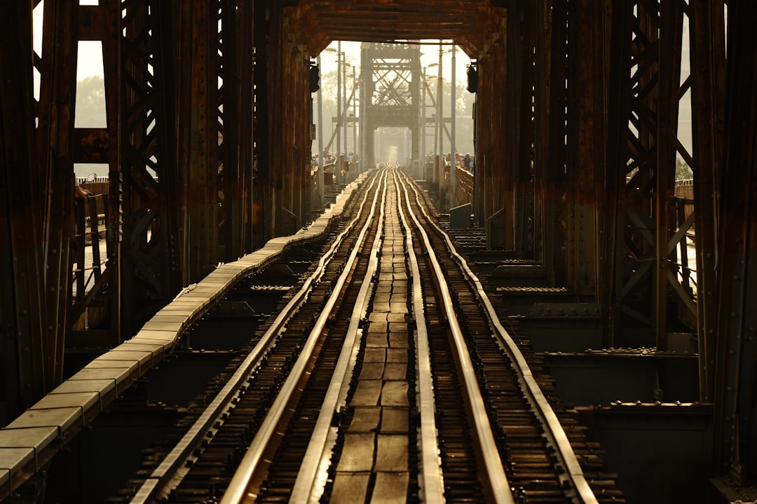 A view of a train track from the top of a bridge