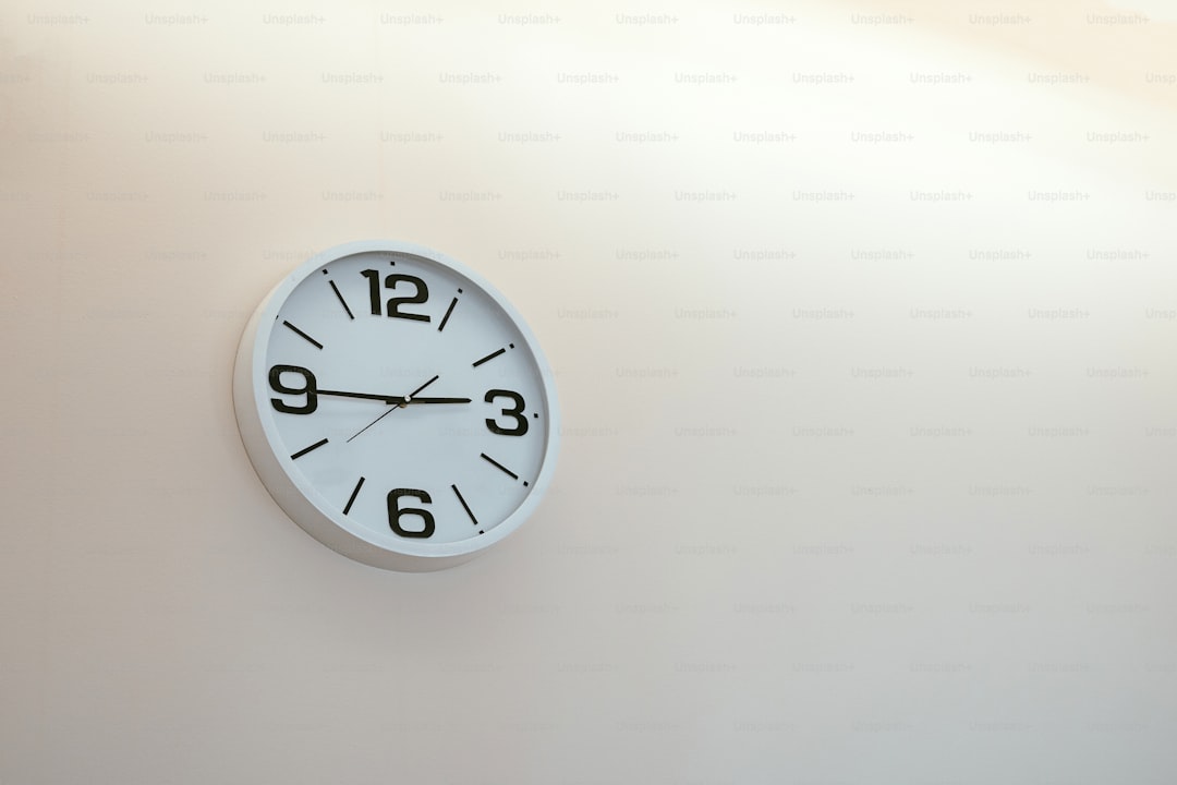 a white clock with black hands